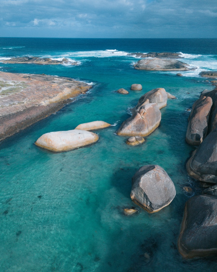 Pale boulders in clear turquoise water at Elephant Rocks