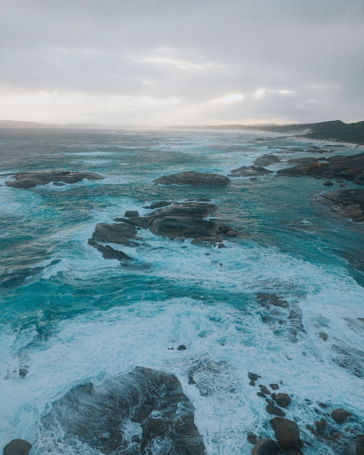 Teal surf breaking over rocks along the south coast